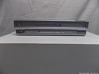 Front view showing DVD tray, VHS slot, control panel