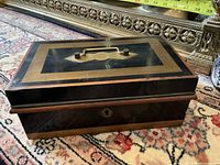 Full view of closed lock box showing brass inlay and handle