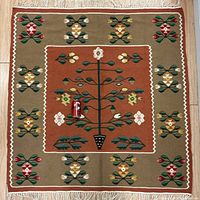 Full view of carpet showing central tree motif and border patterns