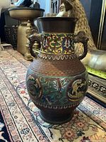 Full view of vase front showing enamel panels and dragon handles