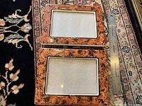 Pair of marbled ceramic frames with ruler for scale