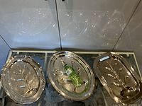 All three footed serving trays with bottle for scale