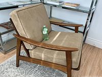 chair with cushions and water bottle for scale