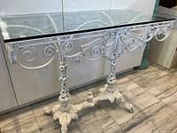 Full view of wrought iron console table with glass top