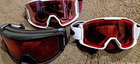 Three goggles laid out showing fronts and lenses