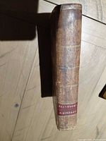 Spine showing brown leather, gilt lines, red title label reading Guthrie's Geography