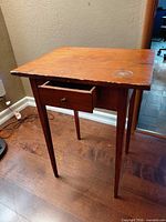 Full view of table showing drawer extended and missing bottom panel