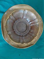 Underside view showing lobed pattern and patina