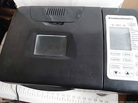 Top view showing black lid with viewing window and control panel