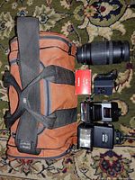 Full lot showing bag, lens, two flashes, adapter and red Canon booklet