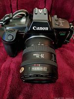 Front view of Canon EOS 630 camera with 28-70mm lens and strap