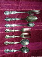 All seven flatware pieces laid out showing full pattern