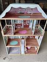 Front view of KidKraft three-level dollhouse interior