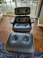 Front view of chair and ottoman showing overall design and upholstery