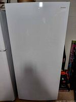 Front exterior view of white Frigidaire upright freezer
