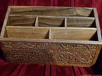 Front view showing carved floral panel and overall structure