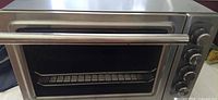 Front view of stainless steel toaster oven showing door and handle