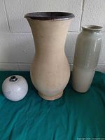 All three vases grouped: beige flared, gradient cylindrical, speckled round