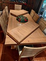 table top with leaves placed diagonally, chairs visible
