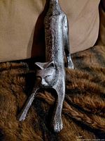 full view of metal cat doorstop showing body and tail