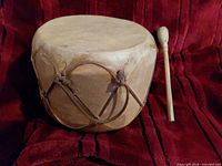 Front angled view of drum with mallet showing overall appearance and lacing