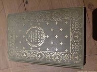 Front cover showing green cloth and gilt decoration