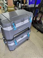 Two stacked Igloo coolers, front view showing latches and logo