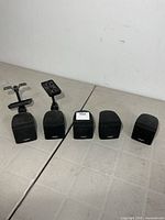Five Bose cube bookshelf speakers, two with mounting brackets