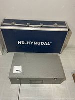 Blue HD-HYNUDAL case and grey metal box closed, top view