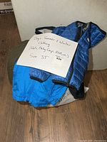 Pile with sign indicating boys summer & winter clothing size 3T