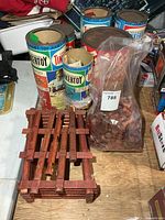 Group of Tinkertoy cans, bag of logs, assembled log structure