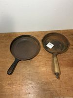 Both cast iron pans top view on table