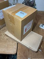 Sealed cardboard boxes containing the two clocks