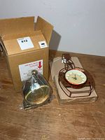 Wall clock, desk clock in plastic, and additional boxed clock on table