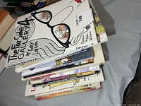 Stack of approximately 12 humor books, top title The Far Side Gallery 4 visible