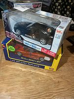 Stacked view of both boxed die-cast cars