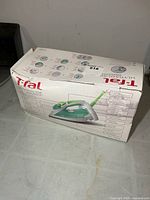 Boxed T-fal Ultraglide Easycord steam iron, front view