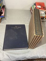 Front view of both hardcover books, one in slipcase