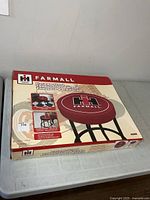 Retail box front showing Farmall logo stool image