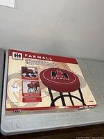 Retail box top showing Farmall stool image and branding