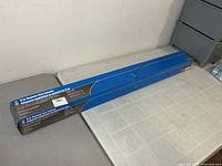 Full view of boxed magnetic floor sweeper