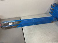 Full view of boxed 15" magnetic floor sweeper