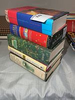 Stack of five hardcover books showing spines