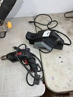 Skil drill and electric planer side by side on tabletop