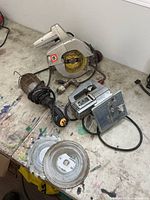 Group shot of circular saw, jigsaw, trouble light, spare blades