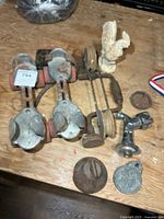 Group shot of entire lot showing roller skates, brace, pulley, rooster, tap, bell and medal