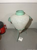 Full view of vase on stand showing size and style