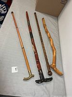 Four canes laid out showing overall designs and lengths