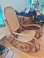 Full view of bentwood rocking chair showing cane seat/back and scroll rockers