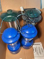 Top view of all four lanterns in box with charge cords